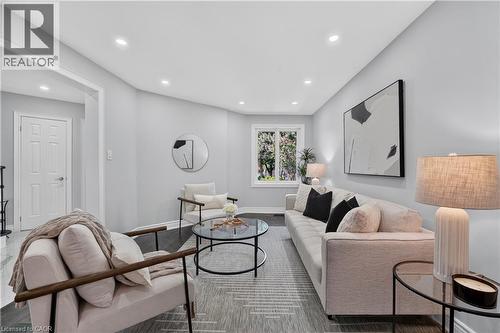 Bright living area featuring recessed ceiling lights, light-toned walls, and wood-finish flooring - 3346 Chartrand Crescent, Mississauga, ON - Indoor