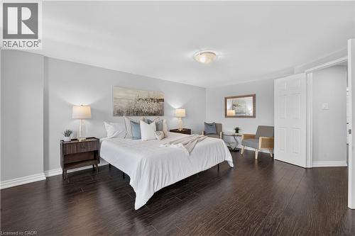 Spacious room featuring dark wood-finish flooring, light grey walls, and white trim - 3346 Chartrand Crescent, Mississauga, ON - Indoor Photo Showing Bedroom