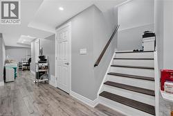 Finished lower level featuring wood-finish flooring, recessed lighting, and a neutral color palette - 