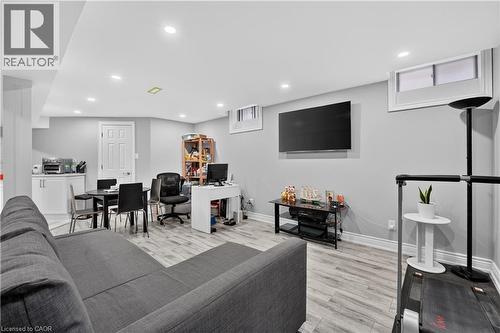 Spacious living area featuring light-toned wood-finish flooring, recessed lighting, and a neutral wall color - 3346 Chartrand Crescent, Mississauga, ON - Indoor