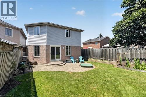 Manicured backyard featuring a stone patio, mature trees, and a two-story residence with brick and siding exterior - 3346 Chartrand Crescent, Mississauga, ON - Outdoor With Exterior