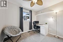 Room featuring light gray walls, plush carpet flooring, and a window with dark gray curtains - 