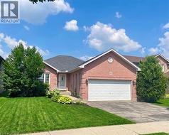 Brick exterior featuring a gabled roof and attached two-car garage - 