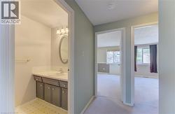 Hallway featuring a built-in vanity with a countertop, integrated sink, and cabinet storage - 