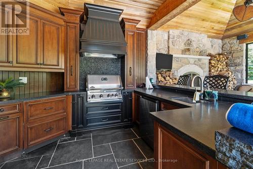 The Spectacular Cabana Features an Outdoor Kitchen - 10090 Pineview Trail, Milton, ON - Indoor Photo Showing Kitchen With Fireplace