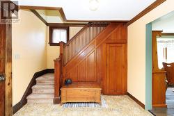 Front foyer with original wood staircase - 