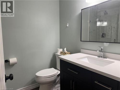 Vanity featuring a white countertop with an integrated sink and chrome faucet - 4187 Weimar Line, Wellesley, ON - Indoor Photo Showing Bathroom