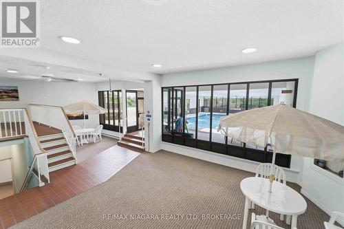 indoor seating area around pool - 1207 - 7 Gale Crescent, St. Catharines (E. Chester), ON - Indoor Photo Showing Bedroom