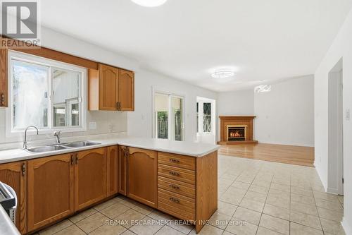 448 Stone Church Road E, Hamilton, ON - Indoor Photo Showing Kitchen With Fireplace With Double Sink