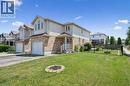 Two-story residence featuring a brick and siding exterior, an attached single-car garage, and a front entrance with a covered porch - 71 Peach Blossom Crescent, Kitchener, ON  - Outdoor 