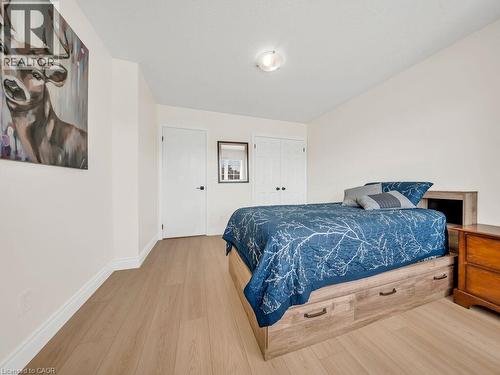 Light wood-finish flooring complements the light wall color and white trim - 39 Baintree Way, Cambridge, ON - Indoor Photo Showing Bedroom