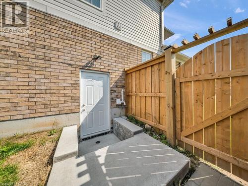 Exterior featuring light brown brick masonry and white vinyl siding - 39 Baintree Way, Cambridge, ON - Outdoor With Exterior