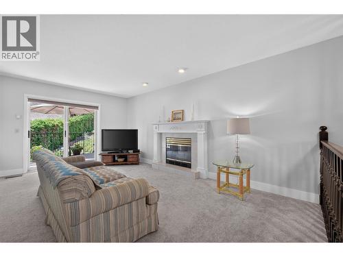 Family room - 602 Glenmeadows Road, Kelowna, BC - Indoor Photo Showing Living Room With Fireplace