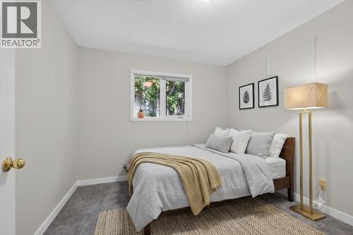 Secondary bedroom on main level *virtually staged* - 602 Glenmeadows Road, Kelowna, BC - Indoor Photo Showing Bedroom