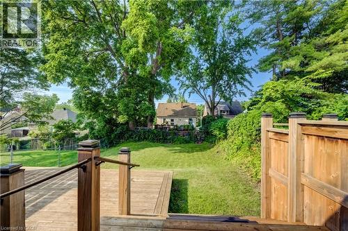 Expansive outdoor deck with natural wood planks and dark metal railings - 55 Rex Drive, Kitchener, ON - Outdoor