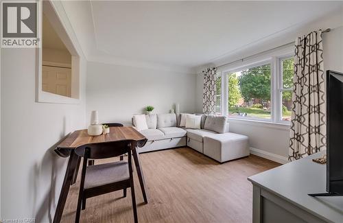 Bright living area featuring wood-finish flooring, white walls, and a large multi-pane window - 55 Rex Drive, Kitchener, ON - Indoor Photo Showing Living Room