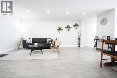 Spacious living area featuring light wood-finish flooring, recessed lighting, and white baseboards - 136 Jansen Avenue, Kitchener, ON - Indoor Photo Showing Other Room