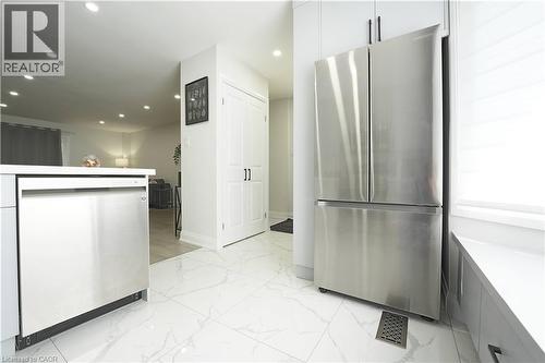Kitchen featuring stainless steel appliances, white cabinetry, and white tile flooring - 136 Jansen Avenue, Kitchener, ON - Indoor