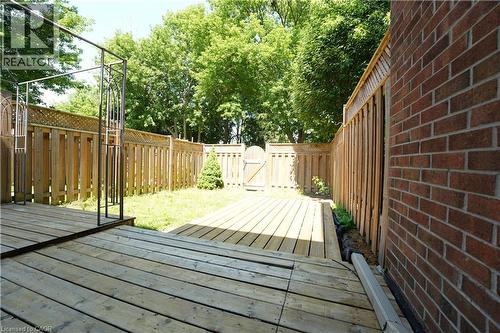 Expansive wood deck overlooking a fenced backyard with a grass lawn - 136 Jansen Avenue, Kitchener, ON - Outdoor