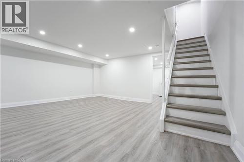 Spacious finished room featuring light wood-finish flooring, white painted walls, and recessed lighting - 136 Jansen Avenue, Kitchener, ON - Indoor Photo Showing Other Room