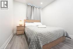 Wood-finish flooring with white baseboards - 