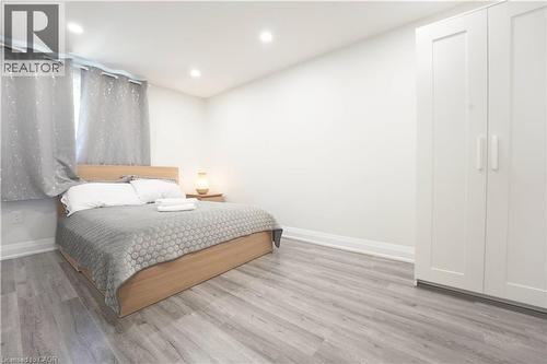 Spacious room featuring light wood-finish flooring and recessed lighting - 136 Jansen Avenue, Kitchener, ON - Indoor Photo Showing Bedroom