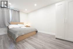 Spacious room featuring light wood-finish flooring and recessed lighting - 
