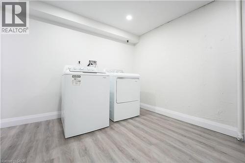 Dedicated laundry area with a top-load washing machine and front-load dryer - 136 Jansen Avenue, Kitchener, ON - Indoor Photo Showing Laundry Room