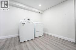 Dedicated laundry area with a top-load washing machine and front-load dryer - 