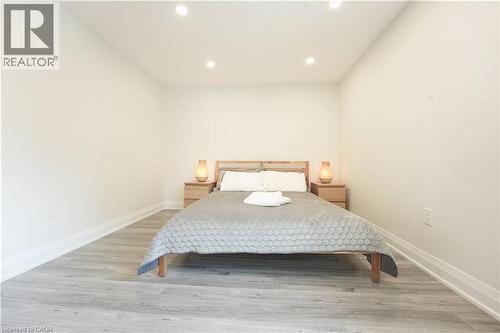 Bedroom featuring recessed lighting, light wood-finish flooring, white baseboards, and neutral wall paint - 136 Jansen Avenue, Kitchener, ON - Indoor Photo Showing Bedroom