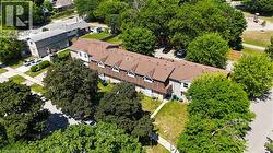 Townhome row with brown shingled roofs and dormer windows - 