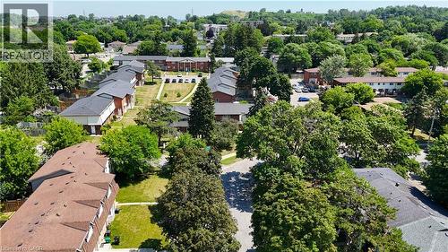 Aerial perspective of a residential complex featuring multiple buildings with gabled roofs and brick exteriors - 136 Jansen Avenue, Kitchener, ON - Outdoor With View