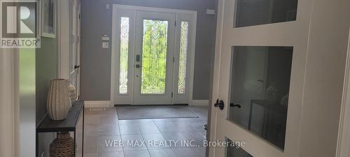 new entry door with side lights, porcelain floor - 22 Ashbury Crescent, Caledon, ON - Indoor Photo Showing Other Room