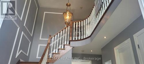Solid staircase with chandelier - 22 Ashbury Crescent, Caledon, ON - Indoor Photo Showing Other Room