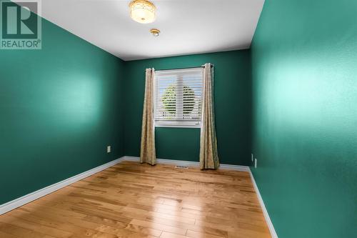 Spacious bedroom with warm hardwood floors and natural light. - 21 Westbrook Landing, Mount Pearl, NL - Indoor Photo Showing Other Room