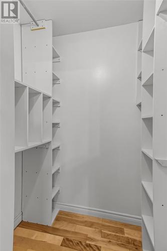 Large walk in closet with custom built in organizers. - 21 Westbrook Landing, Mount Pearl, NL - Indoor With Storage