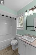 Bright primary bedroom ensuite with updated fixtures and plenty of natural light. - 