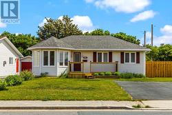 Attractive curb appeal with welcoming front deck and mature landscaping. - 