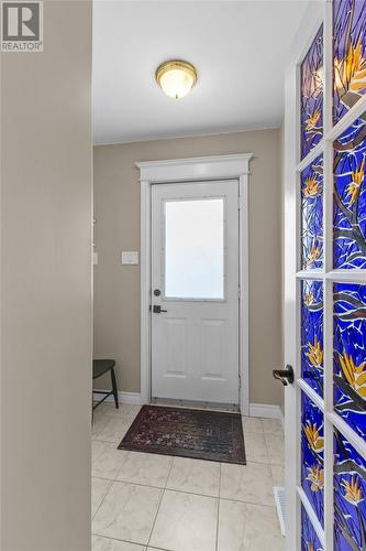 Bright, welcoming foyer with beautiful stained-glass accent door & closet. - 21 Westbrook Landing, Mount Pearl, NL - Indoor Photo Showing Other Room