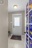 Bright, welcoming foyer with beautiful stained-glass accent door & closet. - 