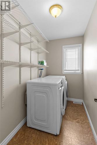 Spacious main floor laundry with abundant built-in storage. - 21 Westbrook Landing, Mount Pearl, NL - Indoor Photo Showing Laundry Room
