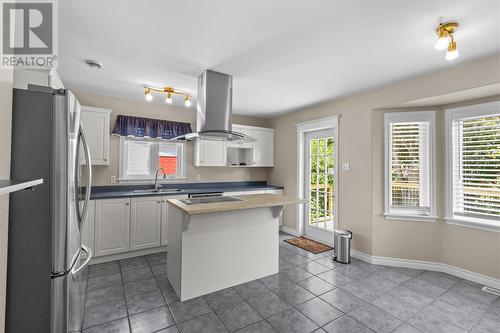 Functional kitchen with centre island and convenient patio access. - 21 Westbrook Landing, Mount Pearl, NL - Indoor Photo Showing Kitchen With Double Sink