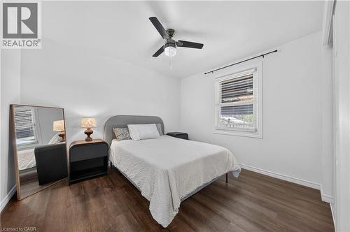 Room with dark wood-finish flooring, white walls, and a window with white blinds - 621 Tate Avenue, Hamilton, ON - Indoor Photo Showing Bedroom