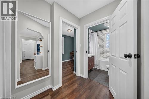 Bathroom featuring a white subway tile surround, wood-finish vanity, and hexagonal floor tiles - 621 Tate Avenue, Hamilton, ON - Indoor Photo Showing Other Room