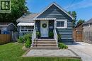 Bungalow exterior featuring horizontal siding, white trim, and a gabled roof - 621 Tate Avenue, Hamilton, ON  - Outdoor 