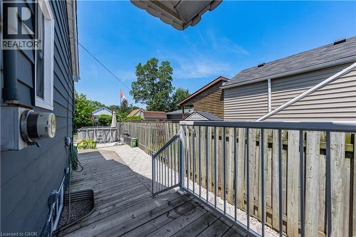 Expansive backyard featuring a wood-finish deck, privacy fencing, above-ground pool, and a gravel patio area - 621 Tate Avenue, Hamilton, ON - Outdoor With Deck Patio Veranda With Exterior