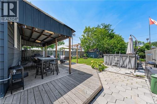 Spacious outdoor area featuring a covered deck, wood decking, and a paver stone patio - 621 Tate Avenue, Hamilton, ON - Outdoor With Deck Patio Veranda With Exterior