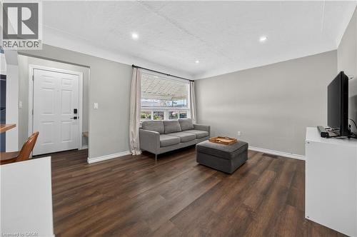 Spacious living area featuring wood-finish flooring, light gray wall paint, and recessed ceiling lighting - 621 Tate Avenue, Hamilton, ON - Indoor