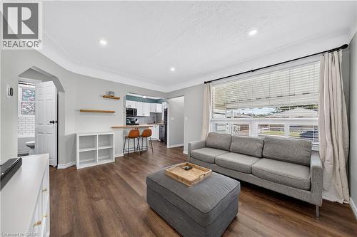 Open-concept living space featuring wood-finish flooring, recessed lighting, and a large window - 621 Tate Avenue, Hamilton, ON - Indoor Photo Showing Living Room