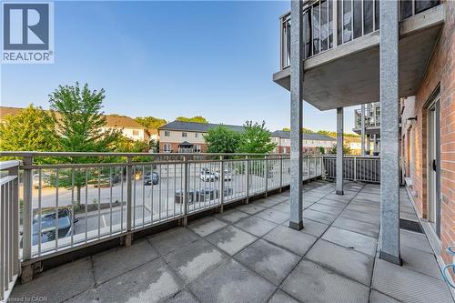 Expansive outdoor balcony featuring concrete tile flooring and metal railings - 155 Water Street S Unit# 203, Cambridge, ON - Outdoor With Exterior
